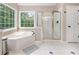 Bright bathroom featuring a soaking tub, and a glass-enclosed shower at 1634 Crittenden Ln, Lawrenceville, GA 30043