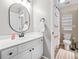 Bathroom with flamingo-themed shower curtain, white cabinets and updated fixtures at 1634 Crittenden Ln, Lawrenceville, GA 30043