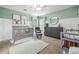 Bedroom with board and batten trim, featuring a crib, dresser, and soft green walls at 1634 Crittenden Ln, Lawrenceville, GA 30043