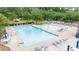 Large community pool with ample seating, umbrellas, and a fountain at 1634 Crittenden Ln, Lawrenceville, GA 30043