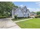Beautiful home with mature trees, long drive, and manicured lawn at 1634 Crittenden Ln, Lawrenceville, GA 30043