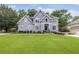 Charming two-story home with a large front lawn and beautiful landscaping at 1634 Crittenden Ln, Lawrenceville, GA 30043