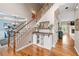 Beautiful foyer with hardwood floors, staircase, and view into dining room at 1634 Crittenden Ln, Lawrenceville, GA 30043