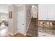 Hallway features a staircase, hardwood floors, and decorative touches, enhancing the home's aesthetic at 1634 Crittenden Ln, Lawrenceville, GA 30043