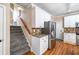 Kitchen and stairwell with granite countertop, stainless appliances, and hardwood floors at 1634 Crittenden Ln, Lawrenceville, GA 30043