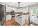 Updated eat-in kitchen features granite countertops, stainless appliances, hardwood floors, and ample storage at 1634 Crittenden Ln, Lawrenceville, GA 30043