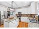 Updated kitchen featuring granite countertops, stainless steel appliances, and a functional island at 1634 Crittenden Ln, Lawrenceville, GA 30043