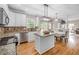 Modern eat-in kitchen with granite countertops, stainless appliances, hardwood floors, and open floor plan at 1634 Crittenden Ln, Lawrenceville, GA 30043