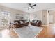 Hardwood floors, recessed lighting, and leather sofas in this bright and airy living room at 1634 Crittenden Ln, Lawrenceville, GA 30043