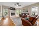 Sun-drenched living room with hardwood floors, fireplace, and classic leather furniture at 1634 Crittenden Ln, Lawrenceville, GA 30043