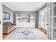 Comfortable living room featuring built-in shelving, and large windows with natural light at 1634 Crittenden Ln, Lawrenceville, GA 30043