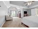 Spacious main bedroom features tray ceiling, fan, and ample natural light creating a relaxing retreat at 1634 Crittenden Ln, Lawrenceville, GA 30043