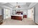 Spacious main bedroom with tray ceiling, ceiling fan, and access to the adjoining bathroom at 1634 Crittenden Ln, Lawrenceville, GA 30043
