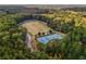 An aerial view showcasing the community's tennis courts, soccer fields, and lush green surroundings at 2747 Livsey Trl, Tucker, GA 30084