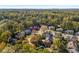 Aerial view of neighborhood and homes, surrounded by lush green trees at 2747 Livsey Trl, Tucker, GA 30084
