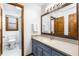 Well lit bathroom featuring a blue vanity, white walls, a toilet, and a shower/tub combo at 2747 Livsey Trl, Tucker, GA 30084