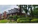 Charming brick home featuring dormer windows, lush landscaping, and a welcoming entrance at 2747 Livsey Trl, Tucker, GA 30084