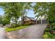 View of home's exterior with attached two-car garage, brick accents, and lush front lawn at 2747 Livsey Trl, Tucker, GA 30084
