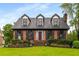 Inviting brick home with dormer windows, complemented by a well-manicured lawn and front yard at 2747 Livsey Trl, Tucker, GA 30084