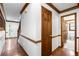 Inviting hallway with hardwood floors, leading to the front door, stairs and a half bathroom at 2747 Livsey Trl, Tucker, GA 30084