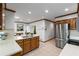 Spacious kitchen with stainless steel appliances, a kitchen island and light tile floors at 2747 Livsey Trl, Tucker, GA 30084