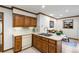 Well-lit kitchen with wood cabinets, an island with sink, and a view to a bright dining area at 2747 Livsey Trl, Tucker, GA 30084