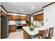 Updated kitchen with stainless steel appliances, an island with bar stool seating, and ample cabinet space at 2747 Livsey Trl, Tucker, GA 30084