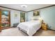 Comfortable main bedroom with light blue walls, a window view, and a neutral color carpet at 2747 Livsey Trl, Tucker, GA 30084