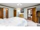 Spacious bedroom with multiple doors, neutral carpet, and light blue walls at 2747 Livsey Trl, Tucker, GA 30084