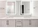 Bathroom with double vanity, framed LED mirrors, and marble countertops at 625 Piedmont Ne Ave # 2004, Atlanta, GA 30308