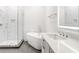 Bright bathroom features a glass-enclosed shower, soaking tub, and a modern vanity with a sleek countertop at 625 Piedmont Ne Ave # 2004, Atlanta, GA 30308