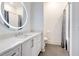 Modern bathroom with round LED mirror, vanity, shower with curtain, toilet and tile floors at 625 Piedmont Ne Ave # 2004, Atlanta, GA 30308