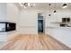 Bright living area featuring hardwood floors, modern fixtures, a fireplace and easy access to the kitchen at 625 Piedmont Ne Ave # 2004, Atlanta, GA 30308