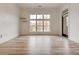 Bright room featuring hardwood floors, two floating shelves, and a large window overlooking the lawn at 625 Piedmont Ne Ave # 2004, Atlanta, GA 30308