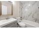 Updated bathroom featuring modern vanity with marble tiling in shower and tub at 1396 Elizabeth Ln, Atlanta, GA 30344
