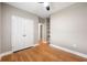 Neutral bedroom featuring hardwood floors, ceiling fan, and a closet with bi-fold doors at 1396 Elizabeth Ln, Atlanta, GA 30344