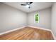 Bright bedroom featuring hardwood floors, a ceiling fan, and a window letting in natural light at 1396 Elizabeth Ln, Atlanta, GA 30344