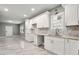 Modern kitchen features new white cabinetry, updated countertops and backsplash, and stainless steel sink at 1396 Elizabeth Ln, Atlanta, GA 30344