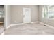 Bright living room with large window, tiled floors, and white door at 1396 Elizabeth Ln, Atlanta, GA 30344