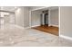 Open concept living room with tile flooring connecting to an updated kitchen at 1396 Elizabeth Ln, Atlanta, GA 30344