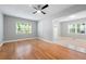 Open concept living room with hardwood floors, ceiling fan, and natural light at 1396 Elizabeth Ln, Atlanta, GA 30344