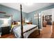 Stylish bedroom featuring a four-poster bed, hardwood floors, and eclectic decor at 2069 Brightleaf Way # 123, Marietta, GA 30060