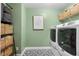 Practical laundry room with side-by-side washer and dryer and ample storage in woven baskets at 2069 Brightleaf Way # 123, Marietta, GA 30060
