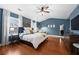 Main bedroom showcasing blue walls, white trim, hardwood floors, a ceiling fan, and decor at 2069 Brightleaf Way # 123, Marietta, GA 30060