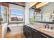 Elegant bathroom featuring a soaking tub, double vanity, granite countertops, and a large window with a view at 490 Marietta St Nw # 307, Atlanta, GA 30313