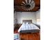 Stylish bedroom with wood ceiling and floors, featuring a statement windmill fan at 490 Marietta St Nw # 307, Atlanta, GA 30313