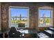 View of the city skyline from an office space with exposed brick and large windows at 490 Marietta St Nw # 307, Atlanta, GA 30313