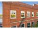 Red brick exterior featuring multi-paned windows reflecting city views with a black fire escape at 490 Marietta St Nw # 307, Atlanta, GA 30313