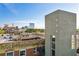 Modern building exterior featuring a rooftop deck with outdoor furniture, set against a city skyline backdrop at 490 Marietta St Nw # 307, Atlanta, GA 30313