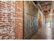 Rustic exposed brick wall and a steel sliding door accents the hallway at 490 Marietta St Nw # 307, Atlanta, GA 30313